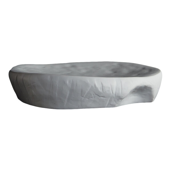 A white, irregularly shaped plate with a textured, stone-like appearance.