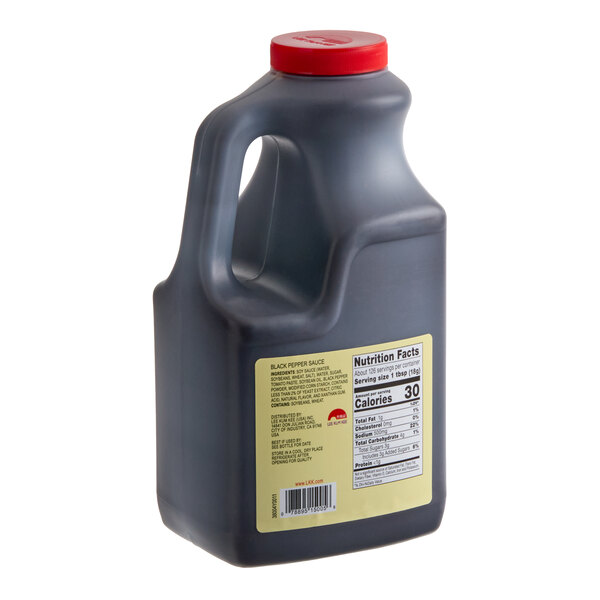 A large black plastic jug with a red cap and a yellow nutrition label on the side.