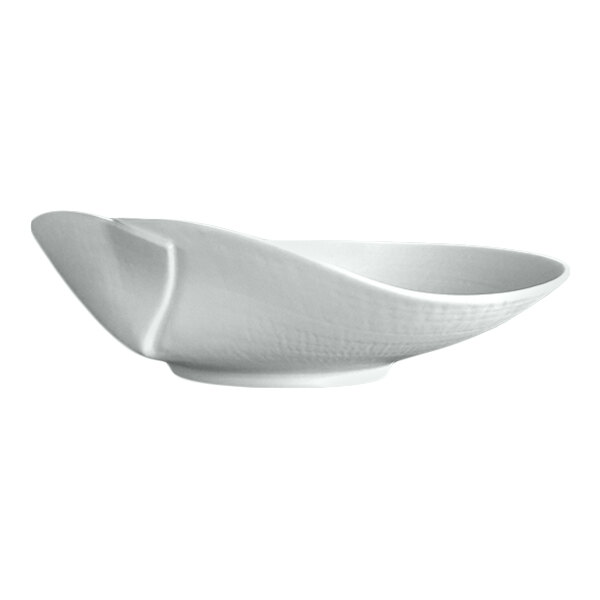 A white porcelain plate with an asymmetrical, modern design and a textured surface.