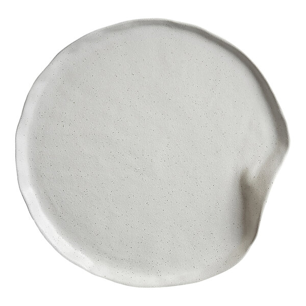 A round, white plate with an irregular, organic shape and a slightly raised edge.