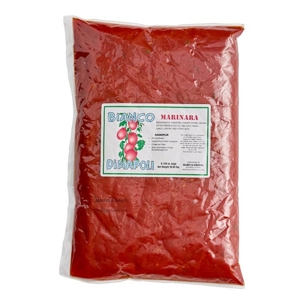 A large, clear plastic bag filled with red marinara sauce and labeled with a Bianco DiNapoli sticker.