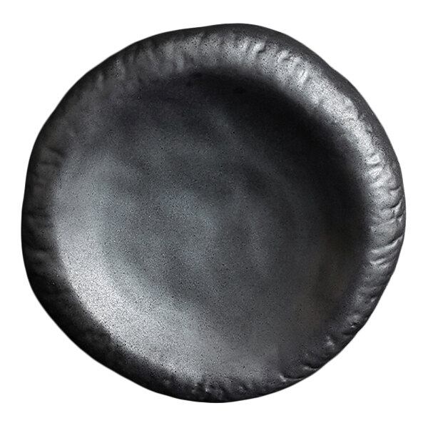 A round, black, stoneware plate with a slightly irregular, textured rim and a matte finish.