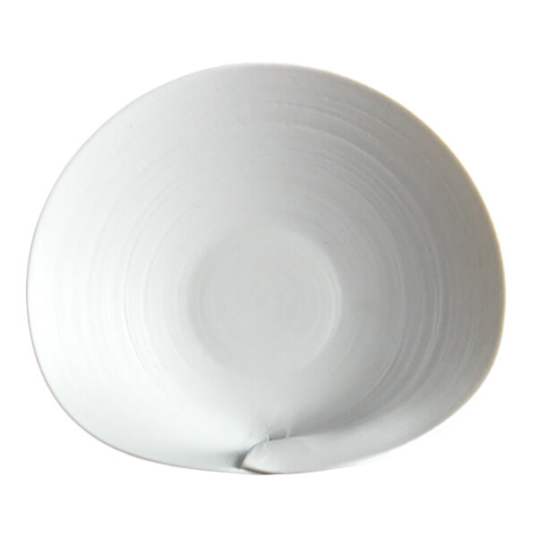 A white, round plate with a slightly irregular, organic shape and a subtle textured pattern.