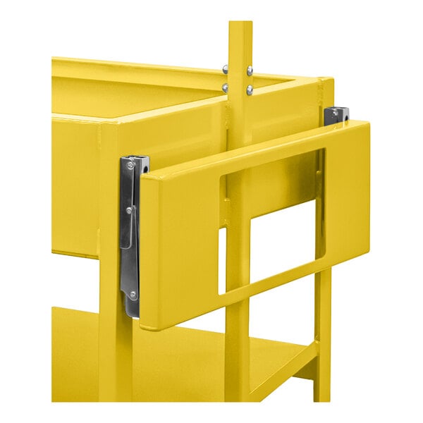 A close-up view of a yellow metal frame with a hinged or folding panel attached by metal brackets.