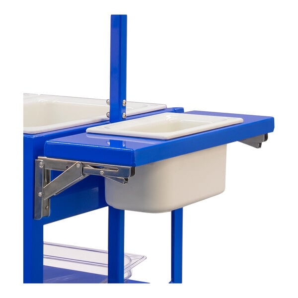 A partial view of a blue metal shelf with a white rectangular pan inserted, supported by metal brackets.