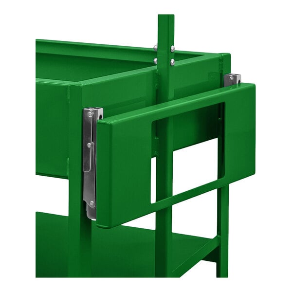 A close-up view of a green metal folding shelf with a rectangular cutout and metal hinges attached to a larger green structure.
