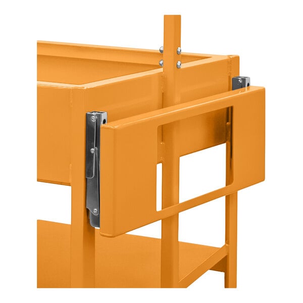 A close-up view of an orange metal frame with a hinged or folding panel attached to it.