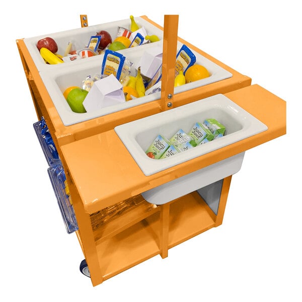 An orange cart with multiple white bins containing assorted food items such as fruit, juice boxes, and packaged goods.
