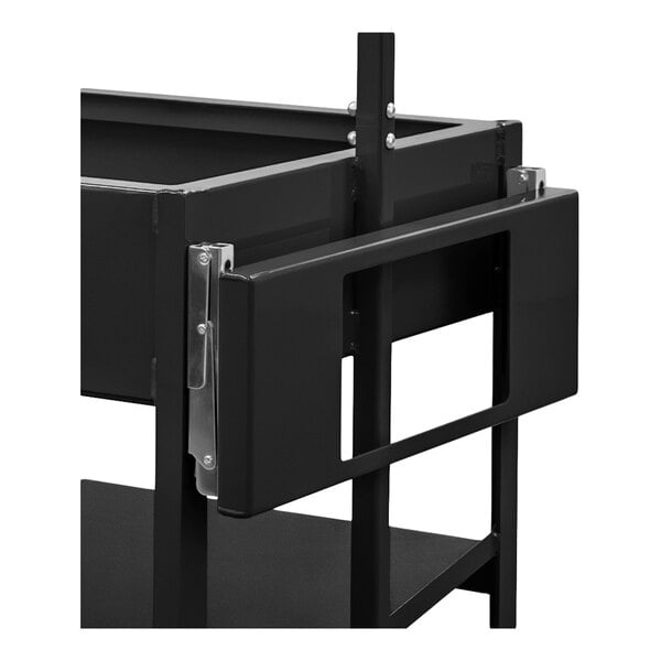 A close-up view of a black metal folding shelf attached to a larger metal frame, with a rectangular cutout in the center.