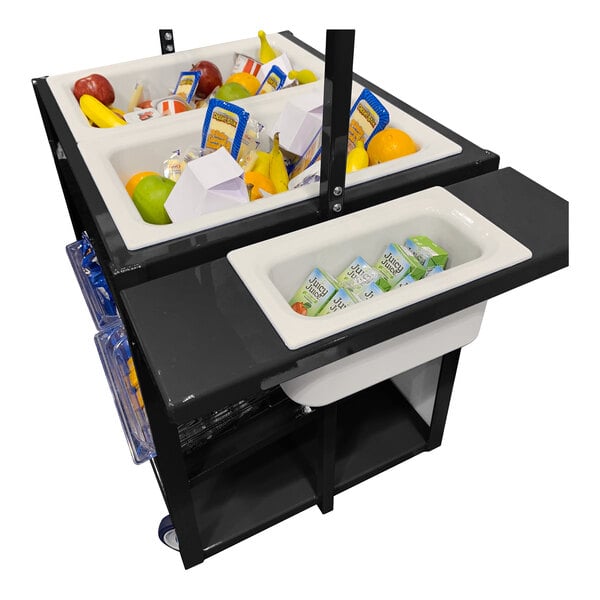 A black cart with multiple white bins containing assorted fruits, packaged food items, and juice boxes.