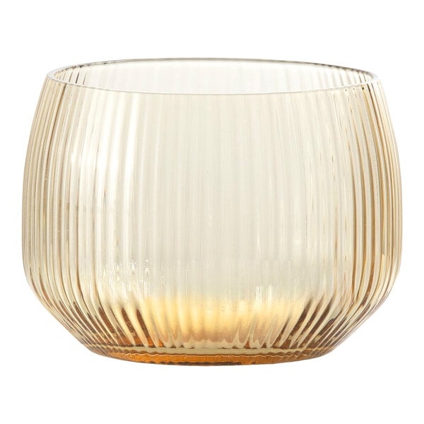 A round, ribbed glass tumbler with a subtle gold tint at the base.