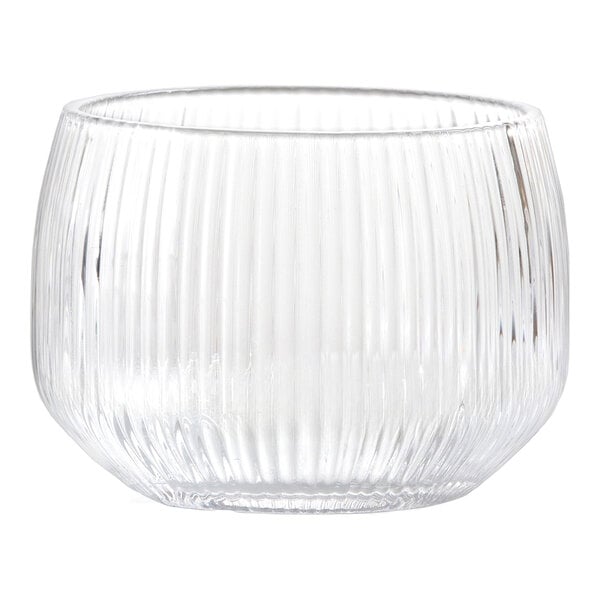A clear, short glass tumbler with vertical ribbed texture and a rounded shape.
