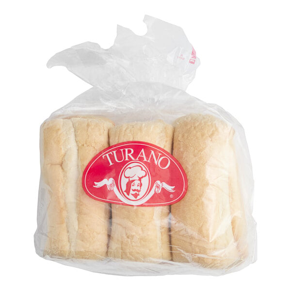 A clear plastic bag containing four light brown sandwich rolls with a red label that says 'Turano' on the front.