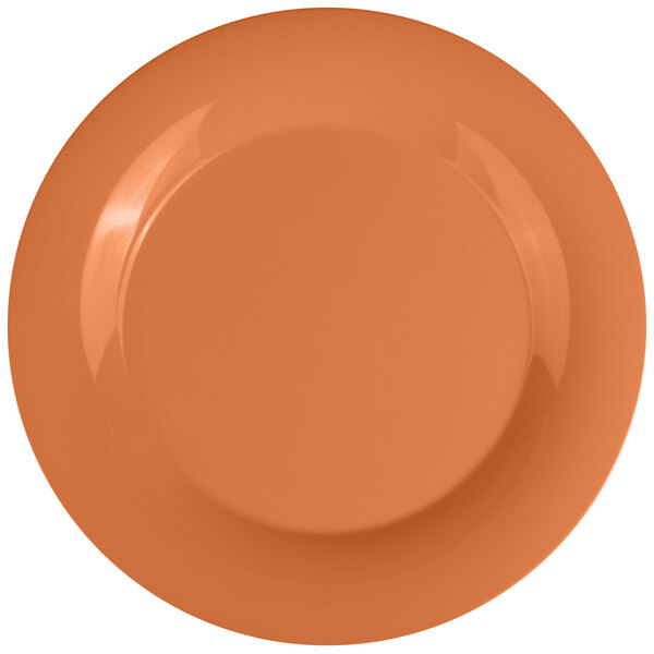 A close-up of a white melamine plate with a pumpkin design in the center.