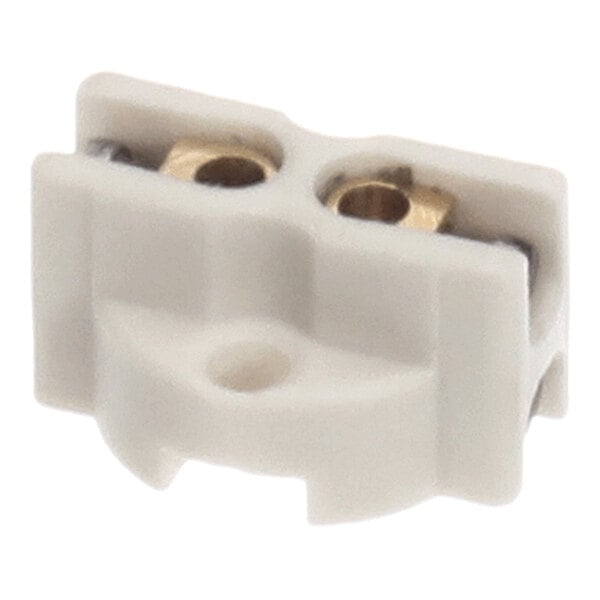 A small, white, rectangular component with two visible brass-colored circular openings and a central mounting hole.