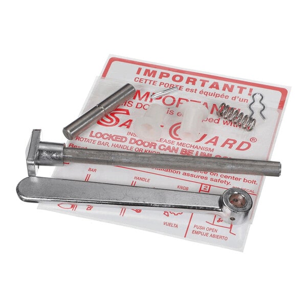 A set of metal and plastic hardware components, including a lever, pins, spring, and clips, arranged on top of an instruction sheet.