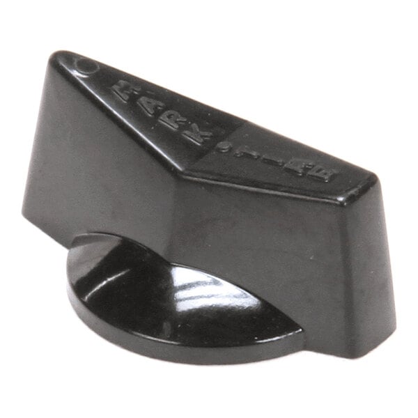 A black, wedge-shaped plastic knob with a flat top and a rounded base, featuring some raised markings or symbols on the top surface.