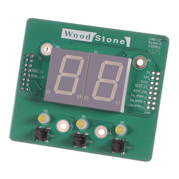 A green electronic circuit board featuring two large 7-segment LED displays, three yellow LEDs, three push buttons, and various labeled connection points.