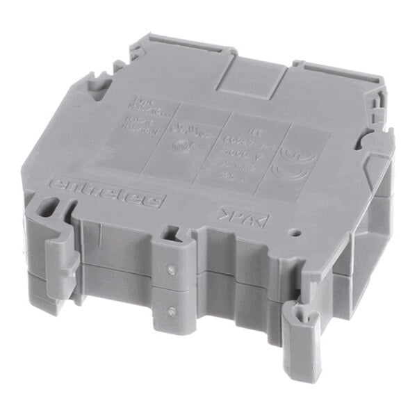 A gray, rectangular plastic component with molded details and embossed text, likely an electrical terminal block.