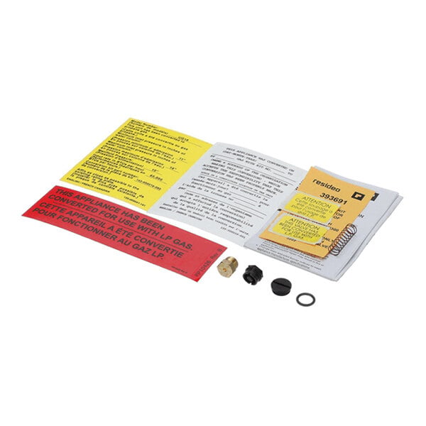 A set of small mechanical parts, labels, and instruction sheets arranged on a white surface.