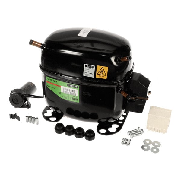 A black metal compressor unit with attached wiring and various mounting hardware, rubber grommets, and screws arranged around it.