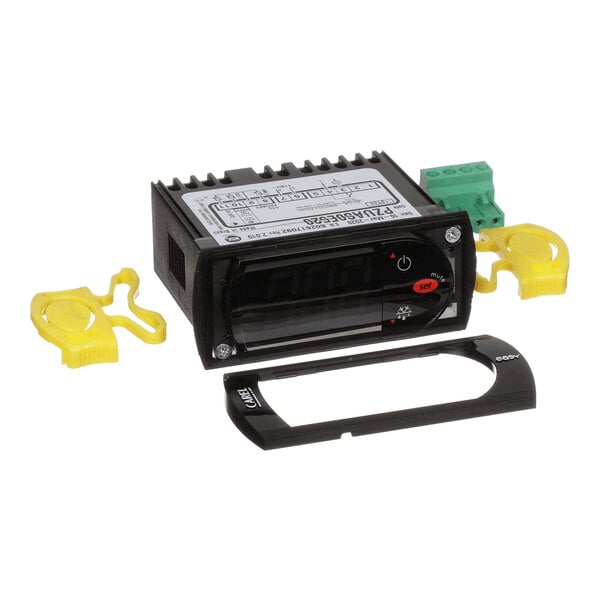 A digital electronic control unit with a display, buttons, and several detachable plastic and electronic components.