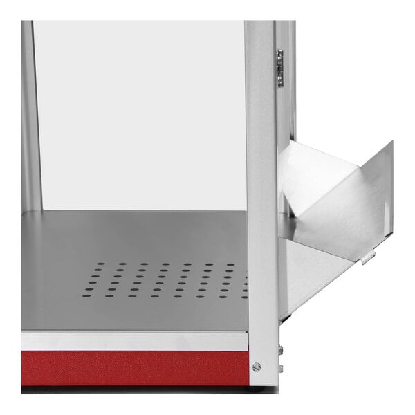 A red and silver Paragon Theater Popcorn Machine with a red lid on a metal shelf.