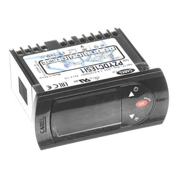 A digital electronic controller with a display screen, labeled buttons, and a wiring diagram on top.