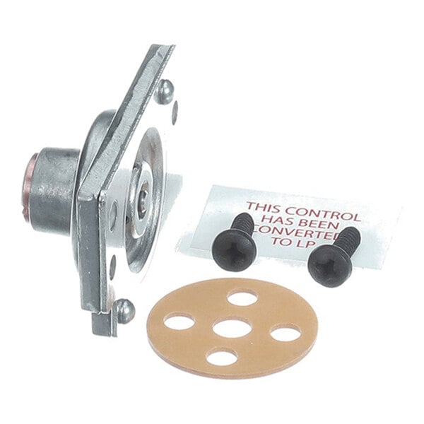 A metal component with a circular base, two black screws, a round gasket with holes, and a label with red text.
