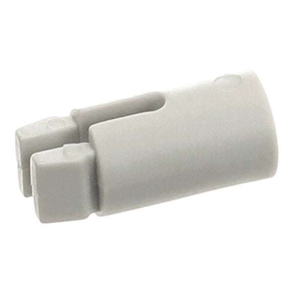 A small, light gray plastic component with a cylindrical shape and two prongs at one end.