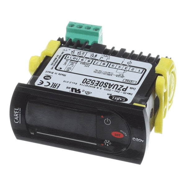 A black electronic control module with a digital display, labeled buttons, and a wiring diagram on top, featuring yellow mounting clips and a green terminal block.