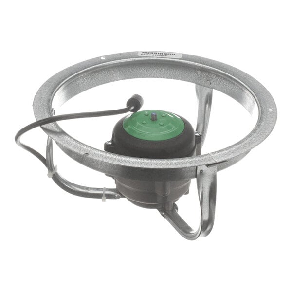 A circular metal frame with a central black and green motor assembly and attached wiring.