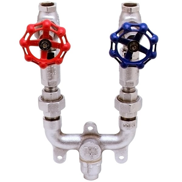 A T&amp;S wall mount mixing valve with red and blue valves on pipes.