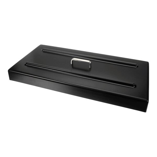 A rectangular black metal cover with a central handle and two raised ridges running parallel to the handle.