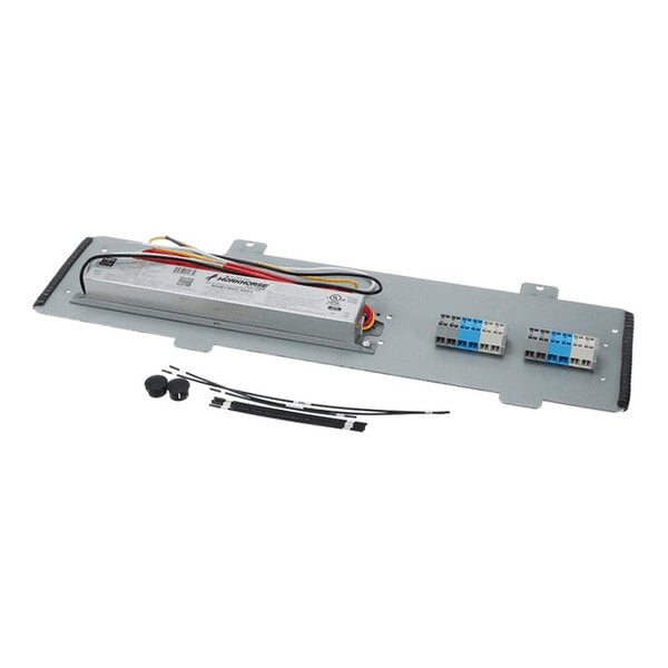 A metal mounting plate with an attached electrical ballast, wiring, terminal blocks, and additional small components such as wire ties and caps.