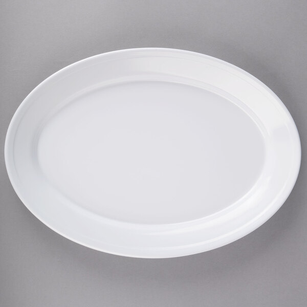A white Carlisle oval platter on a gray surface.