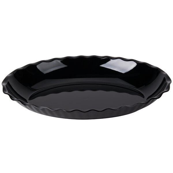 A black, round dish with a wavy, scalloped edge and a glossy finish.
