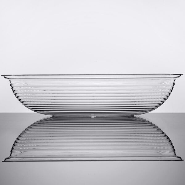 A clear, rectangular ribbed bowl with a shallow profile, shown in a side view with its reflection visible below.