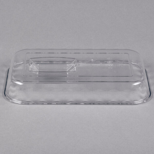 A clear rectangular plastic lid with a raised handle in the center, shown on a plain background.