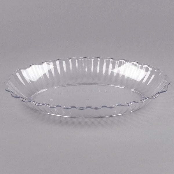 A clear, shallow, round plastic dish with a scalloped edge, shown against a plain background.
