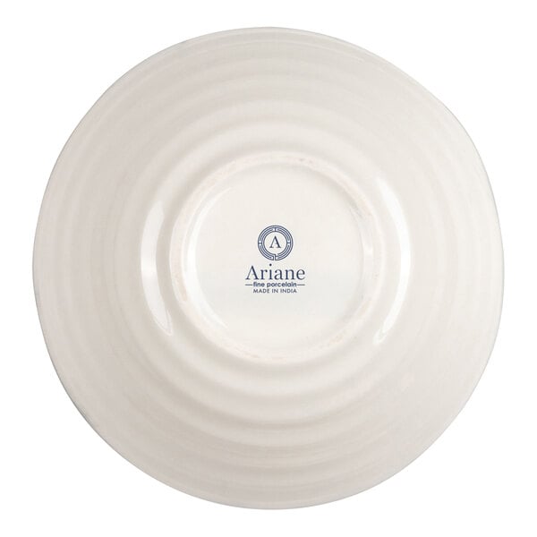 A round, ivory-colored porcelain bowl shown upside down with concentric ridges and a logo that reads 'Ariane fine porcelain MADE IN INDIA' on the base.