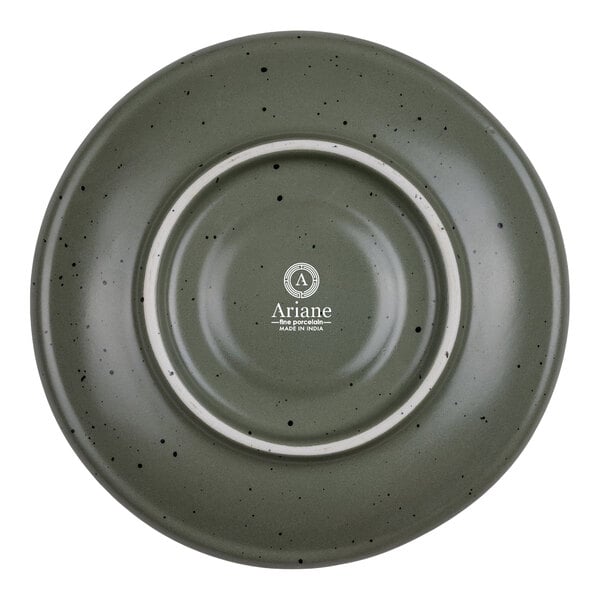 A round, green porcelain saucer with black speckles and a white ring, viewed from above.