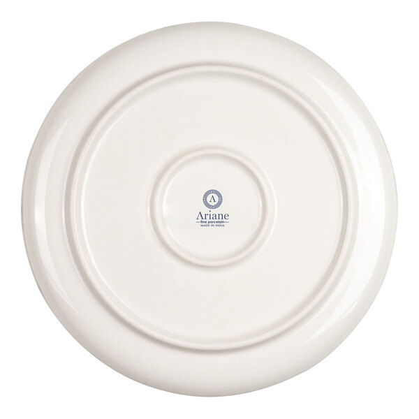 The image shows the underside of a round, ivory-colored porcelain plate with a central logo and text.