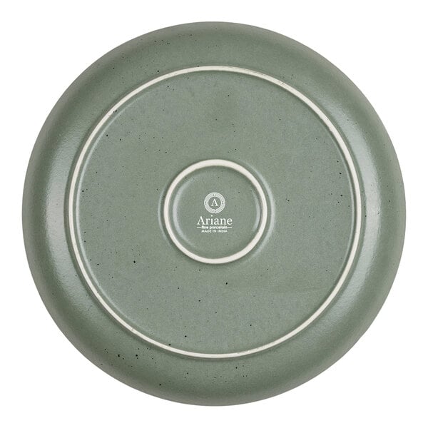 A round, green plate with a smooth finish, subtle speckled pattern, and concentric raised rings on the bottom, featuring the "Ariane" logo and text at the center.
