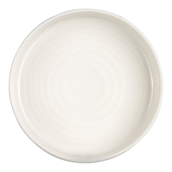 A round, ivory-colored bowl with a smooth, slightly glossy finish and subtle concentric circular patterns on the interior.