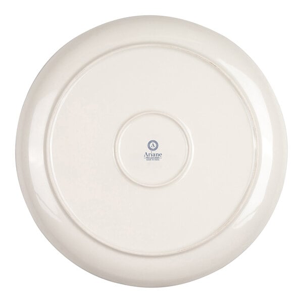 The image shows the underside of a round, ivory-colored porcelain plate with a small logo and text at the center.