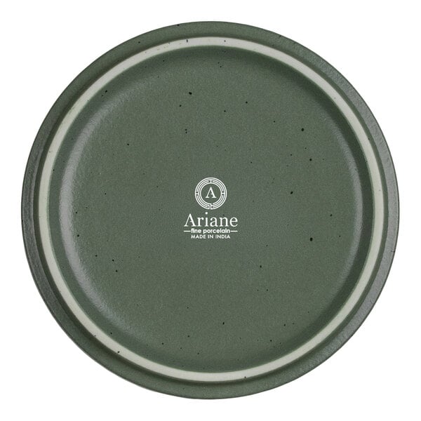 A round, green porcelain plate with a subtle speckled pattern and a white ring near the rim, featuring the Ariane logo and branding in the center.