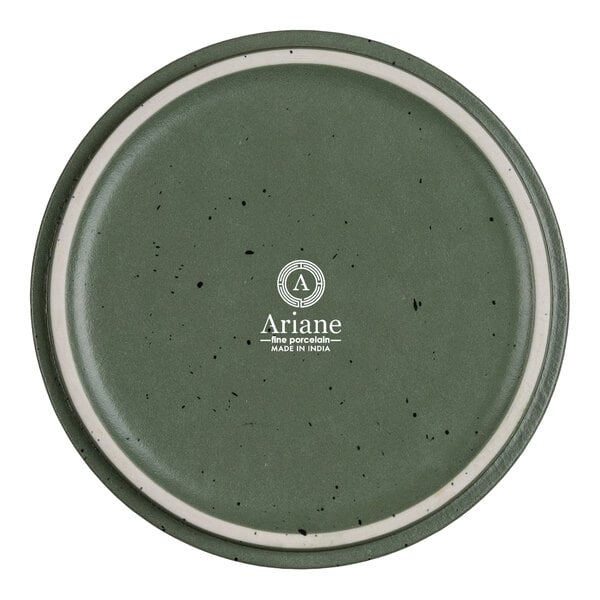 A round, green porcelain plate with a speckled pattern and a white ring near the edge, featuring the Ariane logo and text in the center.
