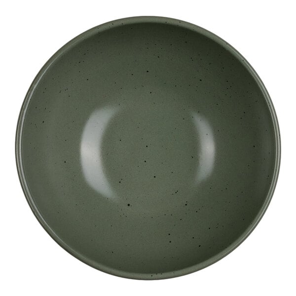 A round, green bowl with a smooth surface and small black speckles, viewed from above.