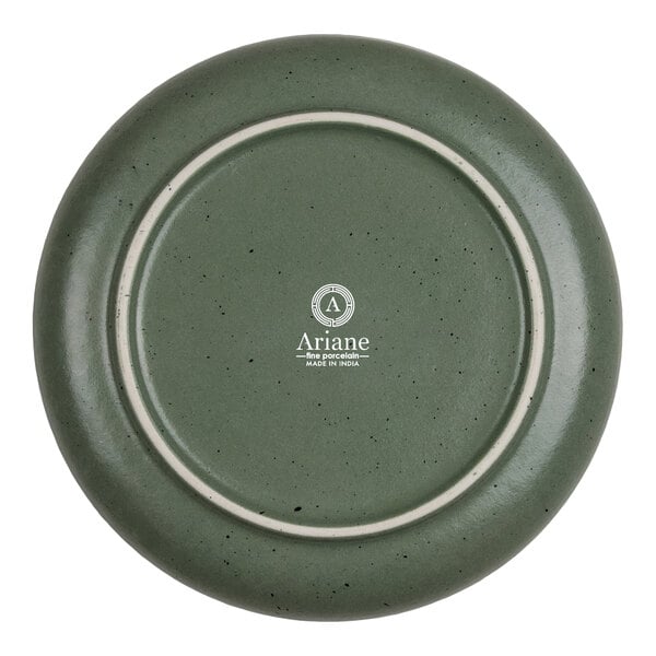 The image shows the underside of a round, green porcelain plate with a speckled finish and a logo that reads 'Ariane fine porcelain MADE IN INDIA' in the center.
